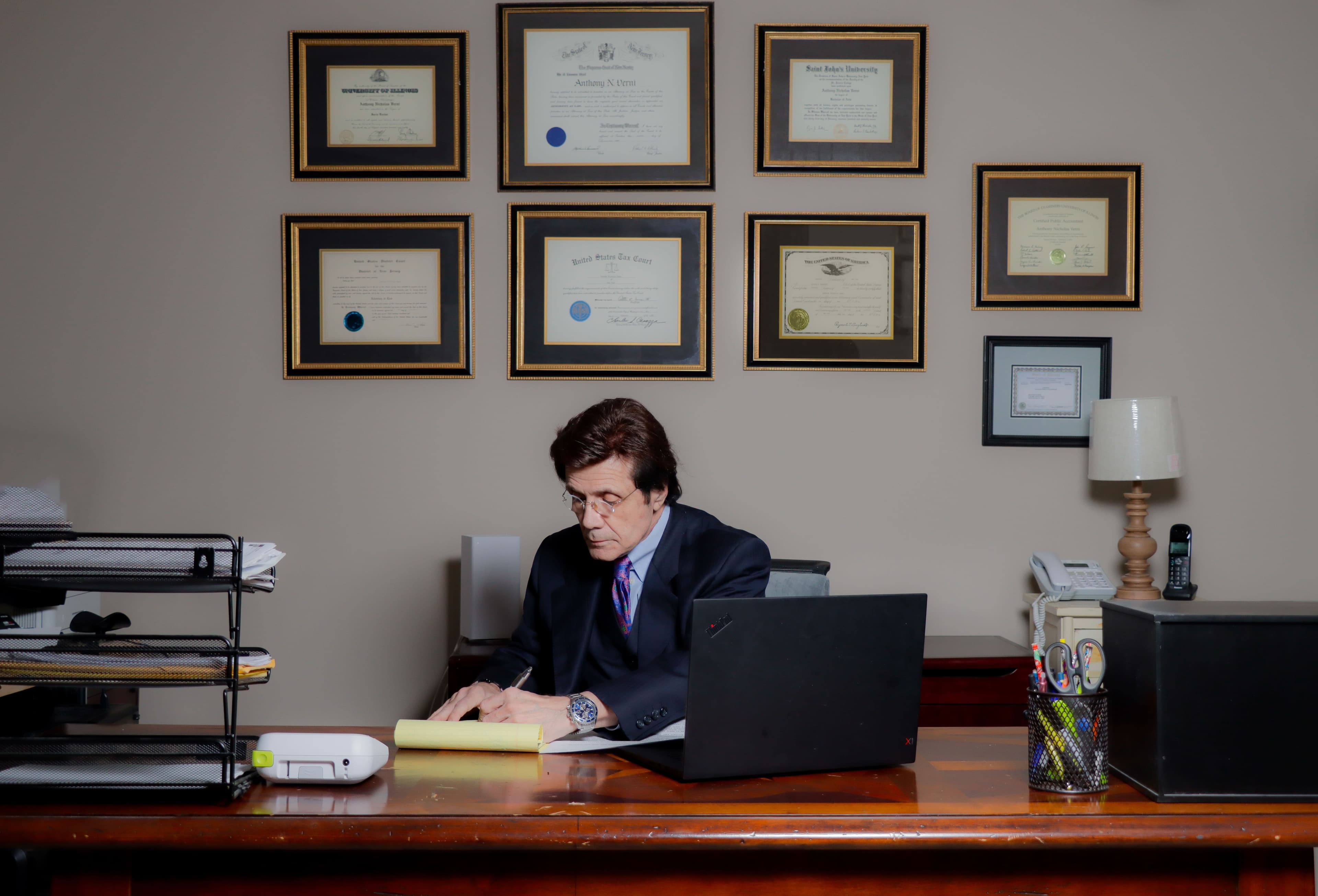 Anthony sitting at his desk looking towards the camera