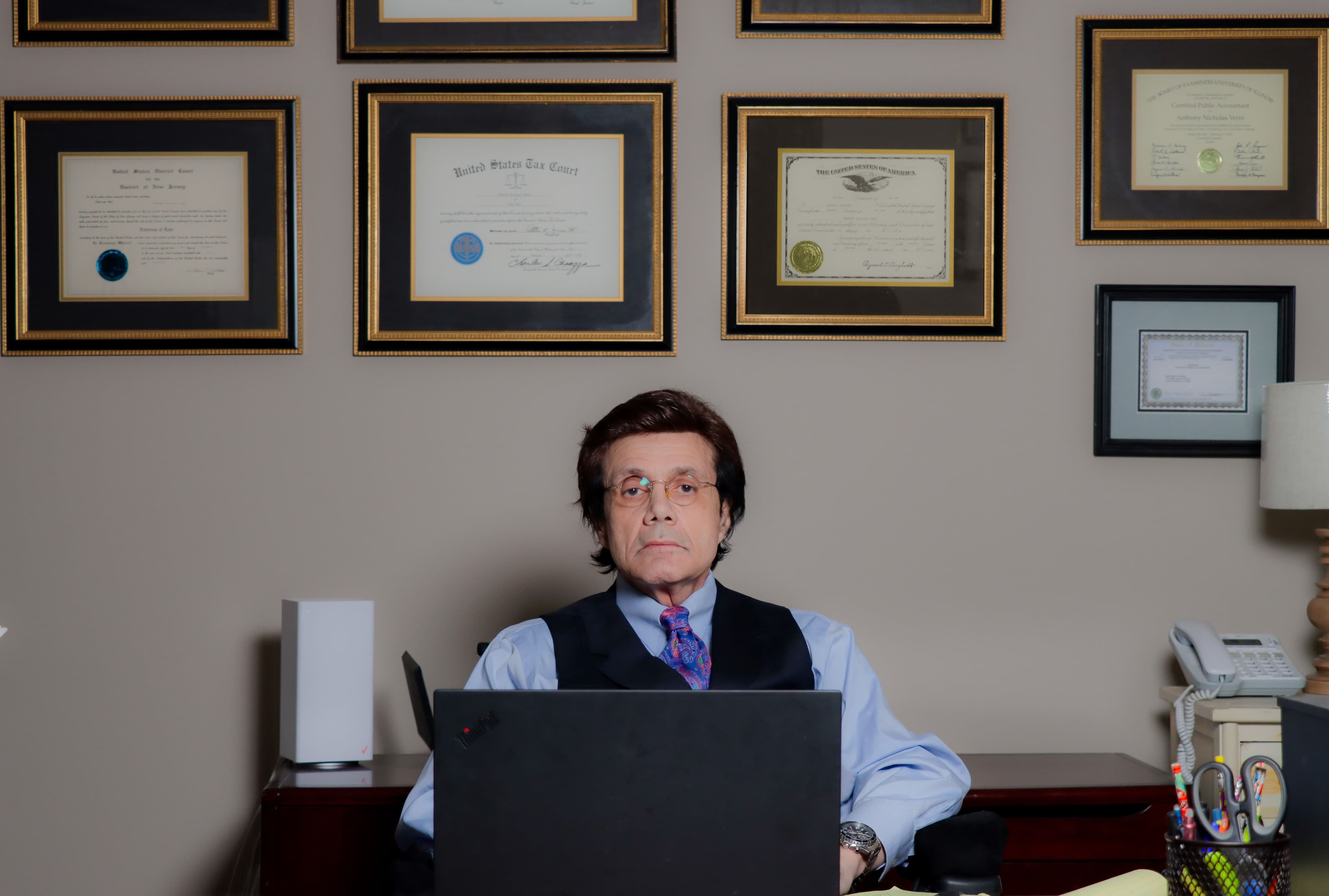 Anthony writing on a notepad at his desk